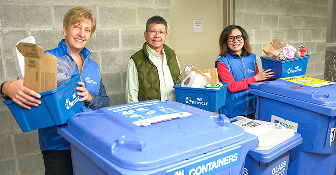 People standing around recycling bins, part of the Zero Waste Ambassador program