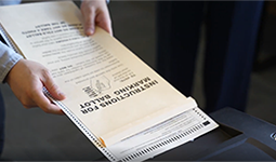 Hands holding voting ballot