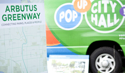 Arbutus Greenway map on board in front of a Pop-Up City Hall cube van