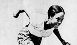 Barbara Howard captured in a historical black and white photo, mid-sprint. 