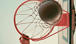 Basketball going through a hoop from a low angle view