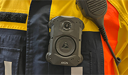 Body-worn camera and radio microphone attached to the uniform of a parking enforcement officer.