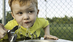 Child drinking from water fountain