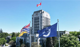 City Hall with BC and Canucks flags in front of the building
