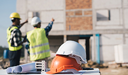 Construction site with hard hats in the foreground.