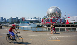 Person biking on seawall around False Creek