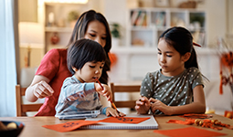 A family does crafts around a table