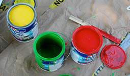 Photo of open yellow, green, and red paint cans