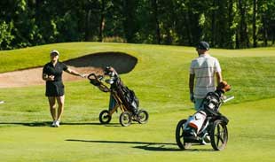 People playing golf on a golf course.