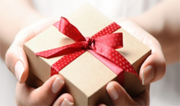 A pair of hands holding a gift box