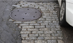 Road showing asphalt and cobblestones