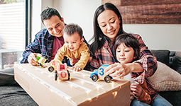 Parents playing with their young children at home