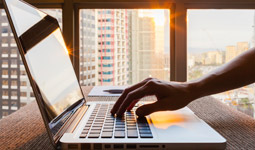 Laptop with apartments in the background