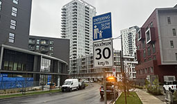 Street with neighbourhood slow zone sign