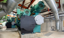 Interior view of large heat recovery equipment and ductwork at the NEU. 