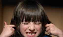 Child plugging their ears hands