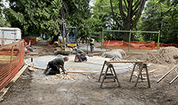 People replacing a playground at a park