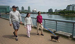 People walking their dog on a leash.