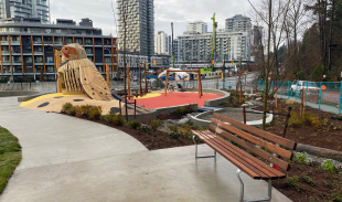 Promontory Park featuring a bench, playground, and path through the park