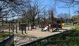 Southwest facing view of existing playground and wading pool