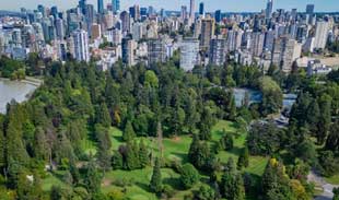 Stanley Park Pitch and Putt greens with downtown buildings in the background