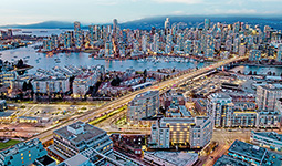 Aerial view of downtown Vancouver at dusk with False Creek, Granville Bridge, and city skyline