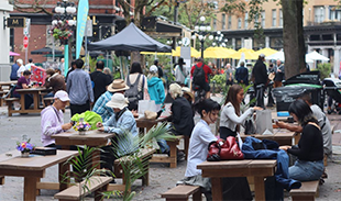 People sitting and eating outdoors in Vancouver's Gastown