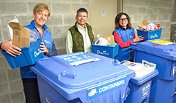 People standing around recycling bins, part of the Zero Waste Ambassador program